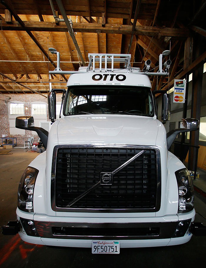 An Otto driverless truck is seen at a garage in San Francisco. An 18-wheel truck barreling down the highway with 80,000 pounds of cargo and no one behind the wheel might seem reckless to most people, even in an age when a few driverless cars already are cruising some city streets. 