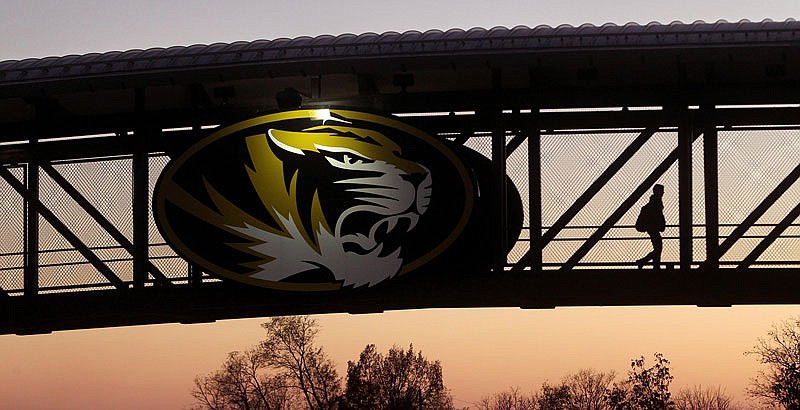 This photo taken Nov. 9, 2015, shows a University of Missouri student walking across the bridge over Providence Road.  