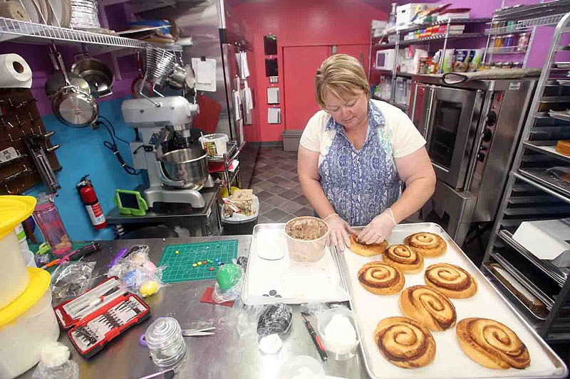 Owner Melisa Stone works on cinnamon rolls Thursday at Mimi's Sweet Treats in Holts Summit, Mo. The bakery has been open approximately three weeks. Stone said the shop is named after her grandchildrens' nickname for her, "Mimi."