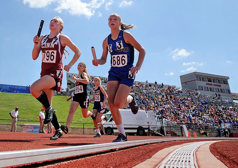 Linn's Harley Nale (left) leads Cole Camp's Tayler Gudde (686) and the rest of the field into the first turn in the Class 2 girls 4x800-meter relay final Saturday, May 21, 2016 at Adkins Stadium in Jefferson City.