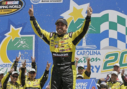 Matt Crafton celebrates with his crew in Victory Lane after winning the NASCAR Truck series auto race at Charlotte Motor Speedway in Concord, N.C., Saturday, May 21, 2016. 