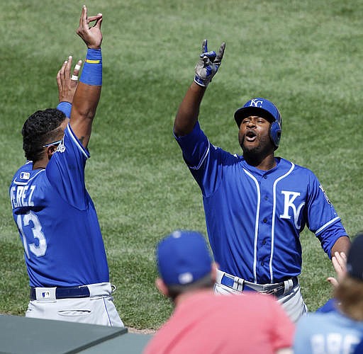 Kansas City Royals' Lorenzo Cain, right, celebrates with Salvador Perez after hitting a solo home run during the sixth inning of a baseball game against the Chicago White Sox, Saturday, May 21, 2016, in Chicago.