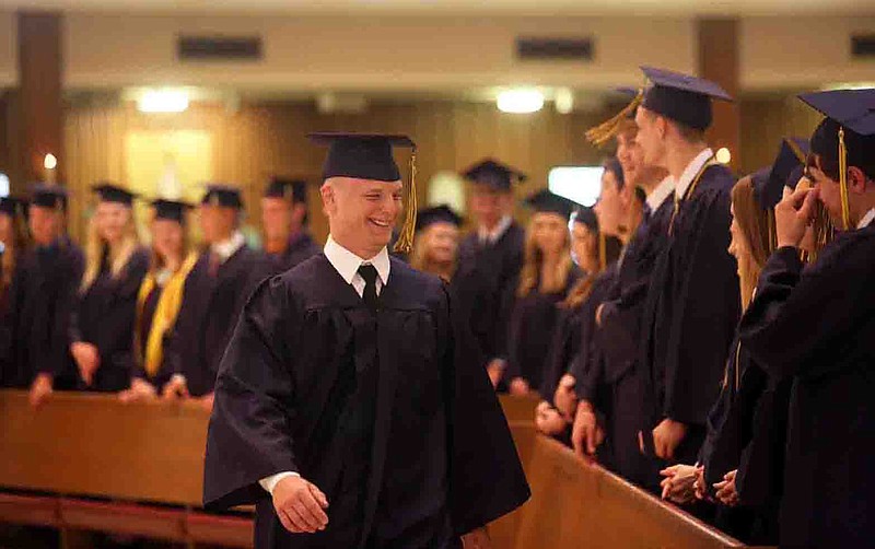 Logan Distler walks into St. Joseph Cathedral during the beginning of Helias Catholic High School's commencement liturgy held on Sunday.