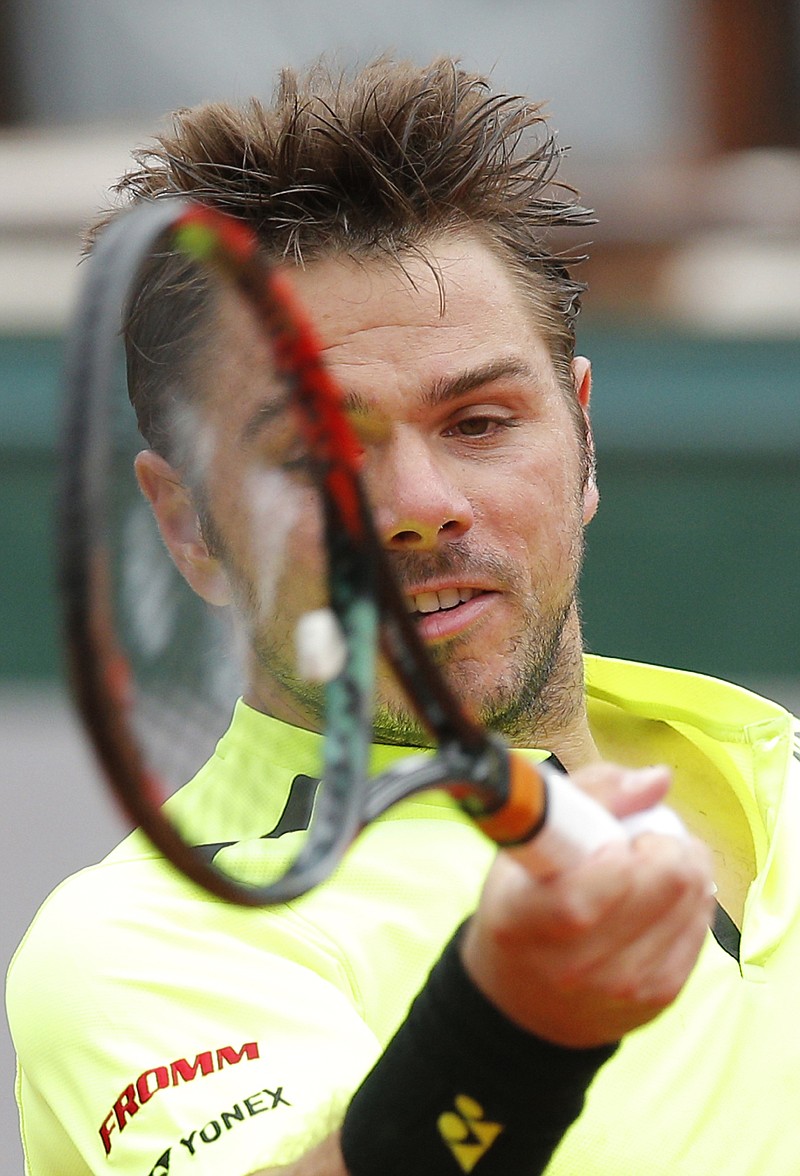 Switzerland's Stan Wawrinka, defending champion, returns the ball to Czech Republic's Lukas Rosol during their first-round match of the French Open on Monday at the Roland Garros stadium in Paris. 
