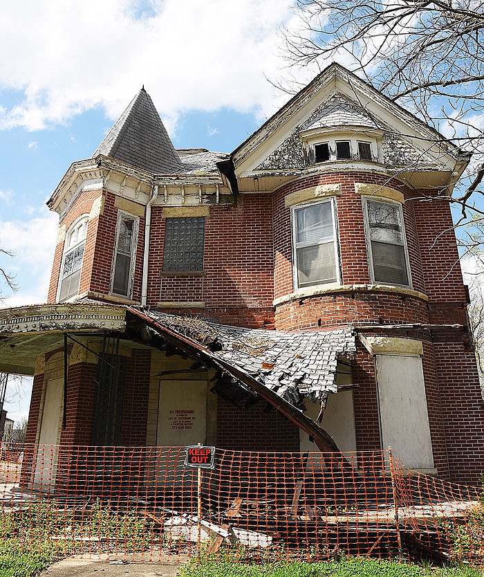 This property at 108 Jackson St. continues to deteriorate as seen by the porch roof collapse. It is one of several properties owned by Barbara Buescher, many of which have been boarded up by the city.