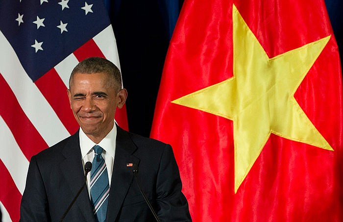 President Barack Obama winks as he arrives for a news conference with Vietnamese President Tran Dai Quang on Monday at the International Convention Center in Hanoi, Vietnam. 