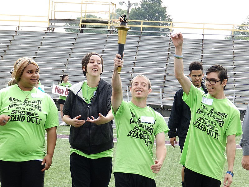 The four graduating seniors from the Life Skills Class in New Boston High School were given the honor of escorting the torch at the end of the torch relay to the Flame of Hope. Justin Crye was granted the distinction of being the one to light the flame. With him are Qrina Rowan, Makayla Hope, and Steven Taylor. 