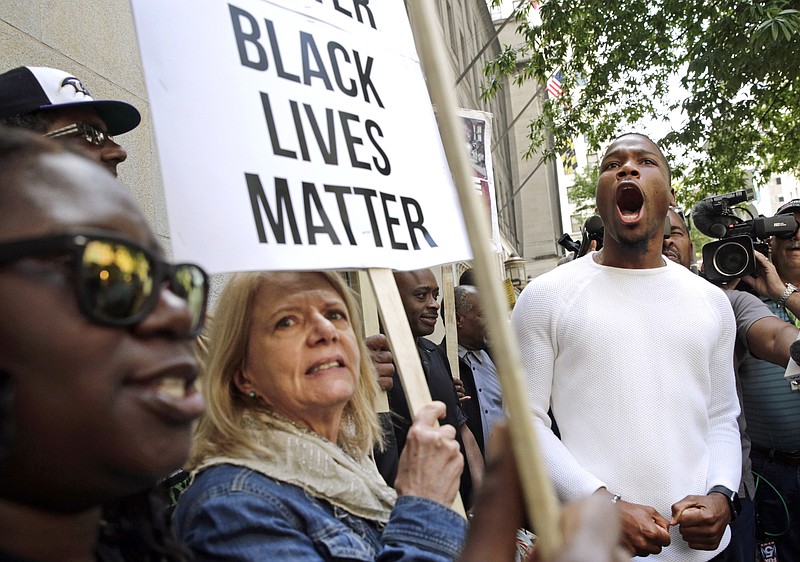 Protesters gather outside of a courthouse after Officer Edward Nero, one of six Baltimore city police officers charged in connection with the death of Freddie Gray, was acquitted Monday of all charges in his trial in Baltimore. 