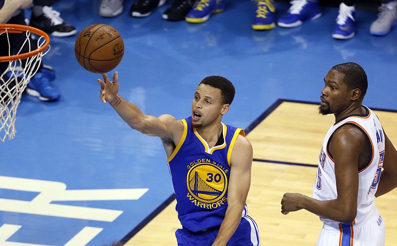 Golden State Warriors guard Stephen Curry (30) gets past Oklahoma City Thunder forward Kevin Durant (35) to shoot during the first half in Game 4 of the NBA basketball Western Conference finals in Oklahoma City, Tuesday, May 24, 2016. 