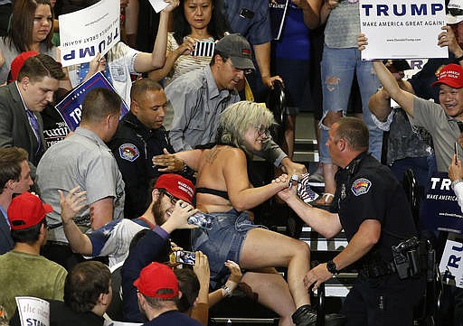 A protester is removed during a speech by Republican presidential candidate Donald Trump at a campaign event in Albuquerque, N.M., Tuesday, May 24, 2016. 