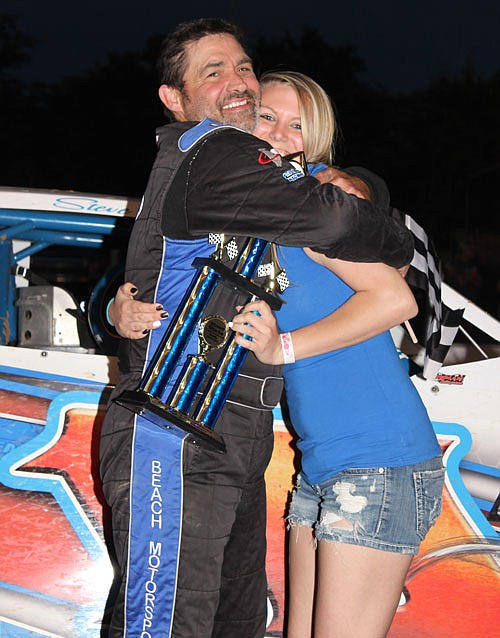 Eldon's Steve Beach celebrates his super stock feature victory with Double-X trophy girl Kelsey Brauner of California.