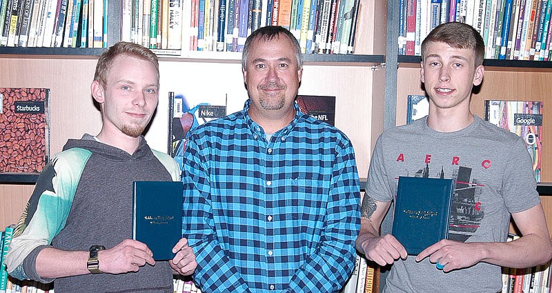 California R-I School Board President Craig Ash, center, presents high school diplomas earned through the Missouri options program to Joran Meyer, left, and Cole Wolverton, right. Each of the two made a presentation on future plans made possible, in part, by obtaining the diploma.