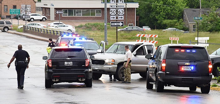 Police cars surround a pickup truck after a man and women led officers on the city's east side.