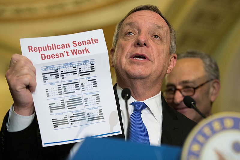 Senate Minority Whip Richard Durbin of Ill., accompanied by Sen. Charles Schumer, D-N.Y., holds up a calendar during a news conference on Capitol Hill in Washington, Tuesday, May 24, 2016. 