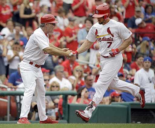 St. Louis Cardinals' Matt Holliday, right, is congratulated by third base coach Chris Maloney after hitting a three-run home run during the sixth inning of a baseball game Wednesday, May 25, 2016, in St. Louis. 