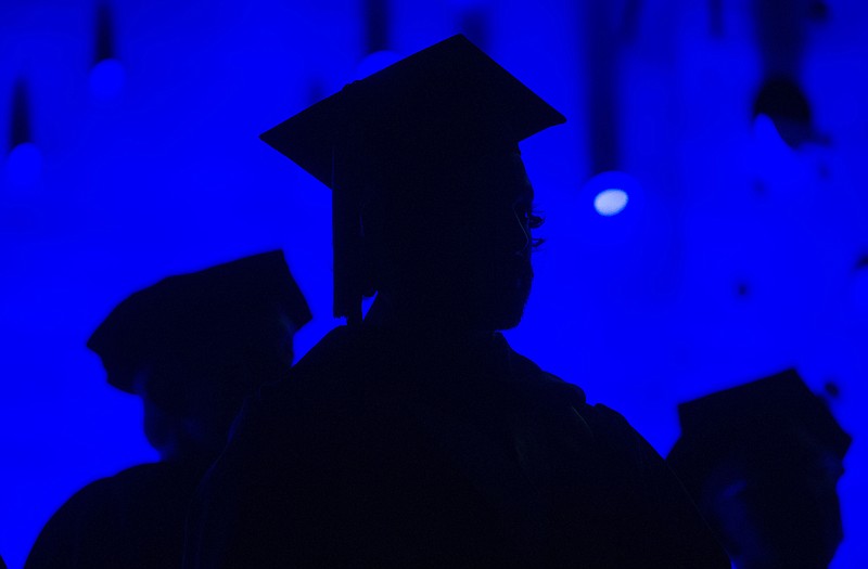 In this Saturday, May 31, 2014, file photo, members of the graduating class and faculty attend the Savannah College of Art and Design commencement in Atlanta. For the first time on record, living with parents is now the most common arrangement for Americans ages 18 to 34, an analysis of Census data by the Pew Research Center has found. The sharp shift reflects a long-running decline in marriage age, amplified by the economic upheavals of the Great Recession. The trend has been particularly evident among Americans who lack a college degree. 