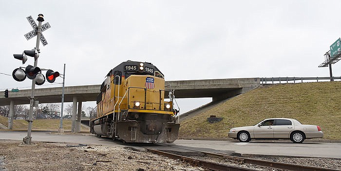 In this Feb. 24, 2016 file photo, a driver waits as a Union Pacific locomotive passes through the intersection of Industrial Drive and West McCarty Street in Jefferson City.