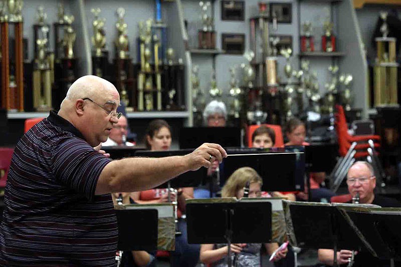 Paul Hinman rehearses the Jefferson City Community Symphonic Band on Tuesday, May 24, 2016, at Jefferson City High School. Hinman was rehearsing for a Memorial Day concert, during which he would direct the community band for the last time.