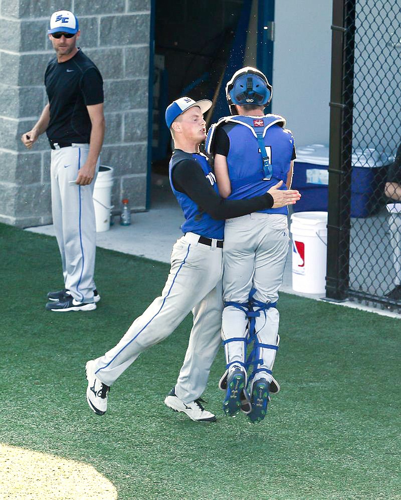 South Callaway sophomore starter Kaden Helsel hoists senior catcher Cameron Richardson in the air after working out of a bases-loaded jam in the fourth inning of the Bulldogs' 6-1 win over Lutheran St. Charles in the Class 3 quarterfinals Wednesday in Mokane. South Callaway head coach Heath Lepper watches in the background.