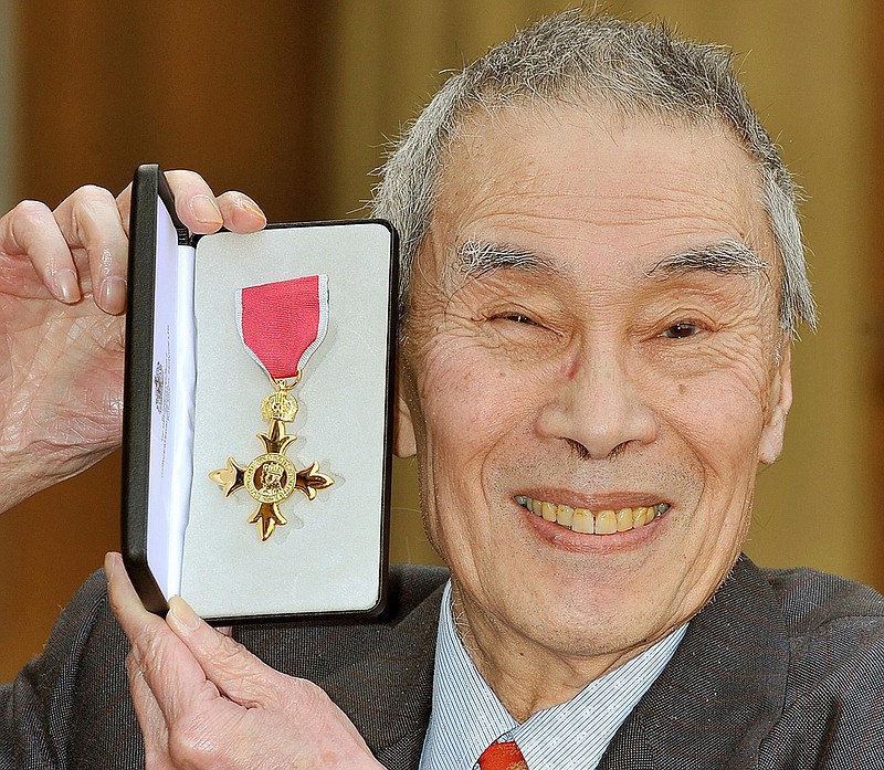 In this file photo dated Feb. 24, 2011, Burt Kwouk, poses after being presented with an Order of the British Empire (OBE) award in London. The actor best known for playing Inspector Clouseau's manservant Cato in the Pink Panther films, has died aged 85, his agent said, Tuesday May 24, 2016, issuing the statement "Beloved actor Burt Kwouk has sadly passed peacefully away 24th May." 
