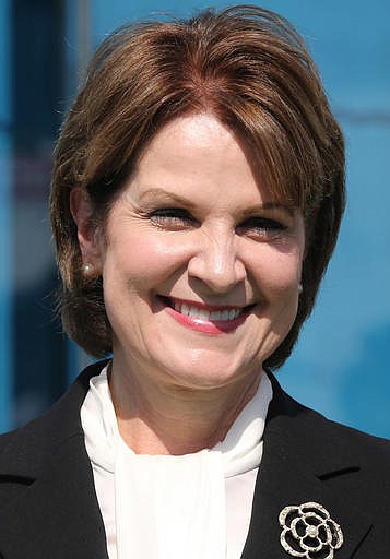 In this Monday, Nov. 9, 2015, file photo, Marillyn A. Hewson, Chairman, President and Chief Executive Officer of Lockheed Martin, poses at the Permanent Chalet commissioning event during the second day of the Dubai Airshow in Dubai, United Arab Emirates. Hewson was one of the highest-paid women CEOs for 2015, as calculated by The Associated Press and Equilar, an executive data firm. 