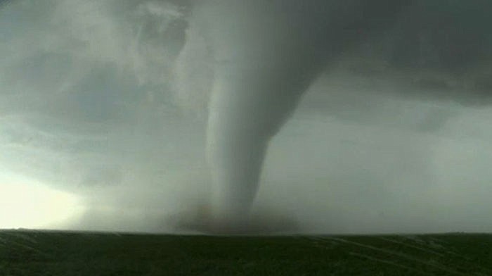 This image, made from a Tuesday video by KWTV-KOTV, shows a funnel cloud moving across the field near Dodge City in Ford County, Kansas. Crews are evaluating the damage Wednesday after tornadoes destroyed several homes in western Kansas as a series of severe storms swept across the Plains. 
