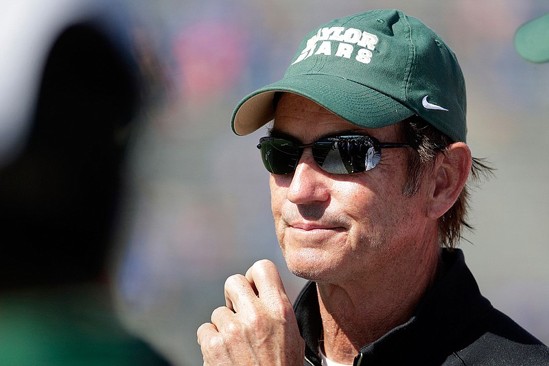 In this Oct. 10, 2015, file photo, Baylor head coach Art Briles watches during the second half of an NCAA college football game against Kansas in Lawrence, Kan. Baylor University's board of regents says it will fire Briles and re-assign university President Kenneth Starr in response to questions about its handling of sexual assault complaints against players.  The university said in a statement Thursday, May 26, 2016, that it had suspended Briles "with intent to terminate."  Starr will leave the position of president on May 31, but the school says he will serve as chancellor.