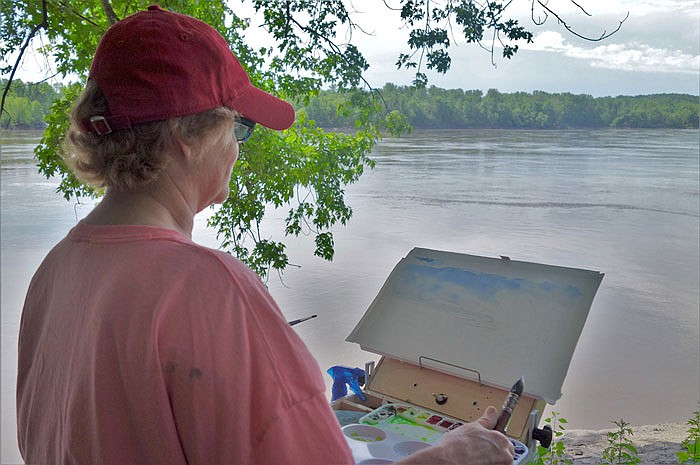 Jill Mccallie of Fulton paints "en plein air" at the Missouri River access near Mokane.