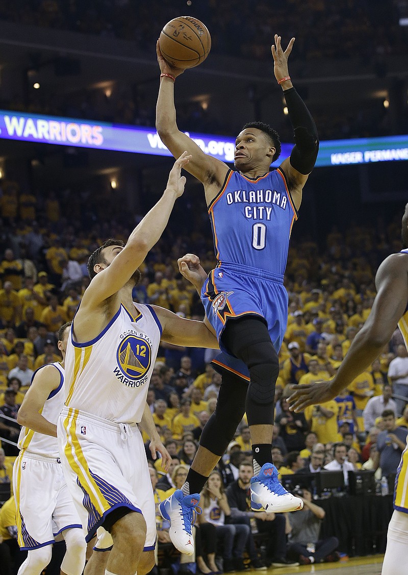 Oklahoma City Thunder guard Russell Westbrook (0) shoots over Golden State Warriors center Andrew Bogut (12) during the first half of Game 5 of the NBA basketball Western Conference finals in Oakland, Calif., Thursday, May 26, 2016. 