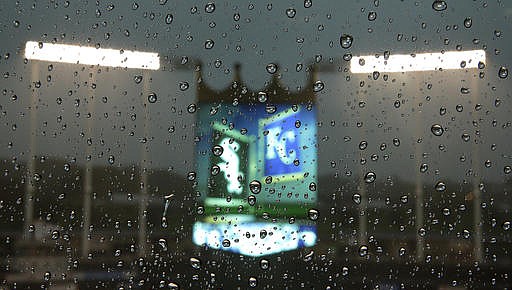 The scoreboard at Kauffman Stadium is seen through a rainy window as a thunderstorm passes through before a baseball game between the Kansas City Royals and the Chicago White Sox on Thursday, May 26, 2016, in Kansas City, Mo. The game was postponed due to rain. 