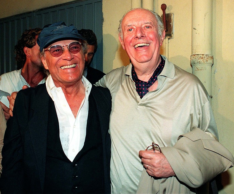 In this Oct. 9, 1997 file photo, Giorgio Albertazzi, left, smiles next to Nobel prize laureate Dario Fo, in Milan, Italy. Albertazzi, a theater and film actor and director famed especially for playing, well into old age, the emperor's role based on "Memories of Hadrian," died at the age of 92 in his native Tuscany, Italy, his family announced Saturday, May 28, 2016. 