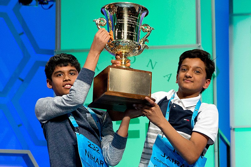 Nihar Janga, 11, of Austin, Texas, and Jairam Hathwar, 13, of Painted Post, N.Y., hold up the trophy after being named co-champions at the 2016 National Spelling Bee, in National Harbor, Md., on Thursday, May 26, 2016.