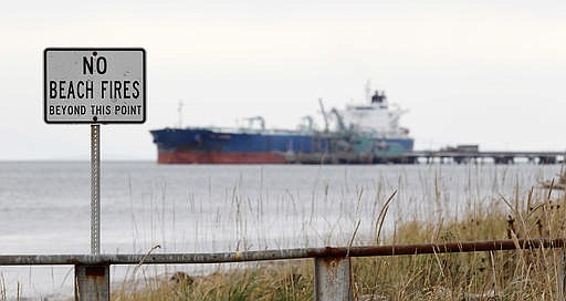 In this Oct. 23, 2012, file photo, a ship is moored at a BP oil refinery in the Strait of Georgia just beyond the location of a proposed coal exporting terminal in Ferndale, Wash.