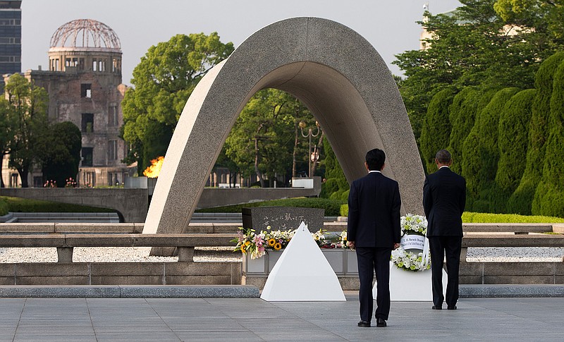 President Barack Obama and Japanese Prime Minister Shinzo Abe participate in a wreath laying ceremony at the cenotaph at Hiroshima Peace Memorial Park in Hiroshima, western, Japan, Friday, May 27, 2016. Obama became the first sitting U.S. president to visit the site of the world's first atomic bomb attack, bringing global attention both to survivors and to his unfulfilled vision of a world without nuclear weapons. Atomic Bomb Dome is seen in the background. 