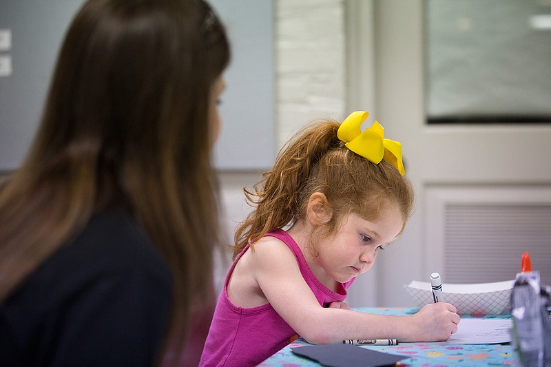 Five-year-old Paige Clayton works on an art project with her mother Saturday, May 28, 2016. Paige made a sign and a rabbit puppet during the Drop In Art Clinic in the basement of the Regional Arts Center in Texarkana, Texas. The one-day free class is part of the Arts on Main summer program. The next Drop In art session is scheduled for July 23.