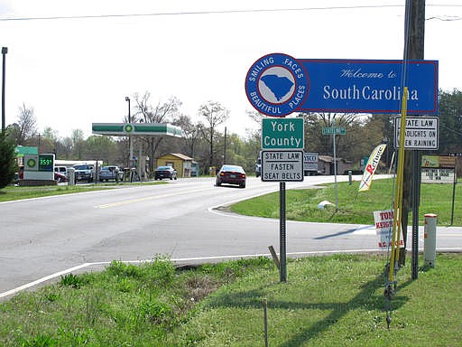 In this March 21, 2012 file photo, a car coming from North Carolina turns into the Lake Wylie Minimart in Lake Wylie, S.C. on Wednesday, March 21, 2012. The store's owner thought his business was in South Carolina, but surveyors have determined it is actually in North Carolina, meaning his gas prices will likely go up 30 cents and he can't sell fireworks. More than 50 families and businesses could find themselves living in new states, if a deal to redraw the North Carolina-South Carolina line is finally approved. 