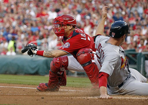 St. Louis Cardinals' Stephen Piscotty, right, slides safely into home as Washington Nationals catcher Jose Lobaton cannot make the tag in time after a single by Cardinals' Greg Garcia during the second inning of a baseball game at Nationals Park, Saturday, May 28, 2016, in Washington. 