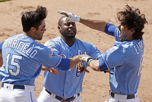 Kansas City Royals' Brett Eibner, right, celebrates with Lorenzo Cain, center, and Whit Merrifield (15) after hitting the game-winning RBI single during the ninth inning of a baseball game against the Chicago White Sox Saturday, May 28, 2016, in Kansas City, Mo. The Royals won 8-7. 