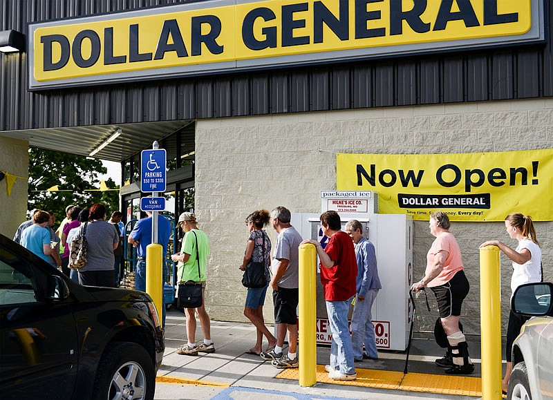 Dozens of Linn, Mo., residents make their way through the doors of the new Dollar General store at 1302 E. Main St. after waiting in line early Saturday morning, May 28, 2016. The newly constructed store replaces the one a few blocks away that opened in 2001.
