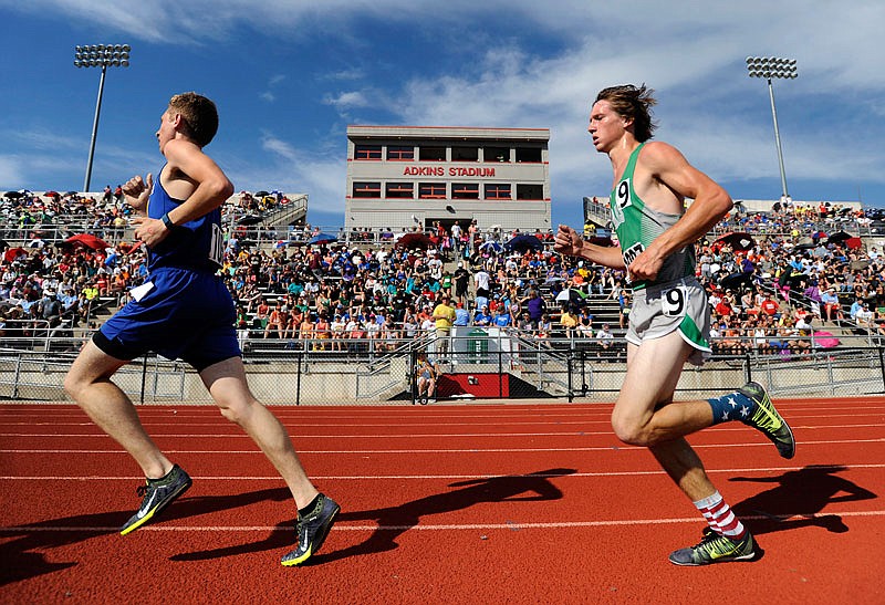 Jason Otto of Blair Oaks (right) runs in front of the stands at Adkins Stadium during the Class 3 boys 3,200-meter run on Saturday, May 28, 2016.