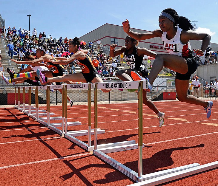 Brianna Holley of Jefferson City (right) runs in the Class 5 girls 100-meter hurdles Saturday, May 28, 2016, at Adkins Stadium in Jefferson City.