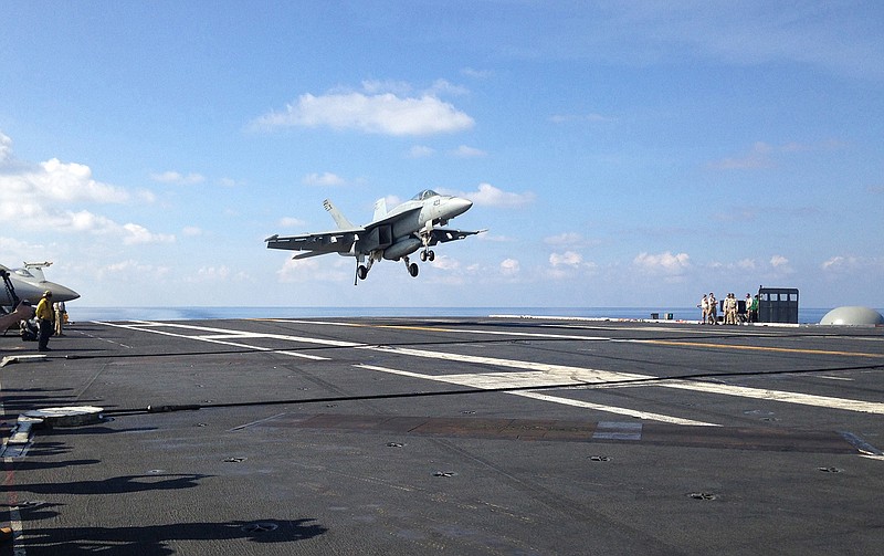 In this Friday, April 15, 2016 file photo, an FA-18 jet fighter lands on the USS John C. Stennis aircraft carrier in the South China Sea while U.S. Defense Secretary Ash Carter visited the aircraft carrier during a trip to the region. American ships and fighter jets maneuvering across the South China Sea and the Sea of Japan represent the "new normal" in U.S.-Pacific relations despite rising tensions with China and Russia. U.S. moves in recent months have led to angry protests from Beijing and Moscow. They say the Obama administration is fueling unrest in the Asia Pacific, and is conducting for illegal and unsafe transit in the region. 