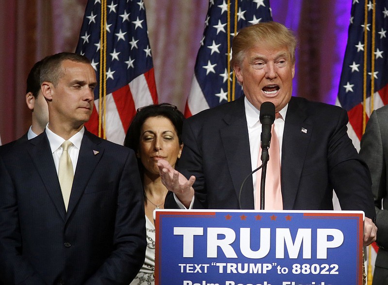 In this March 15, 2016, file photo, Republican presidential candidate Donald Trump speaks to supporters at his primary election night event at his Mar-a-Lago Club in Palm Beach, Fla., as campaign manager Corey Lewandowski listens at left. Trump's penchant for encouraging rivalries and pitting even those closest to him against each other is roiling his Republican presidential campaign as he plunges into the general election. The tensions boiled over last week with the abrupt ouster of political director Rick Wiley, who left the campaign after just six weeks. 