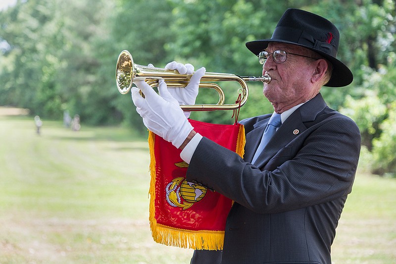 Ray Whitney, a U.S. Marine Corps veteran who served from 1962 until 1966, performs Taps during Sunday morning's Memorial Day observation at East Memorial Gardens Cemetery. Throughout the ceremony, veterans reminded those in attendance that Memorial Day is not about a three-day weekend and barbecue, but about honoring those who died in war.