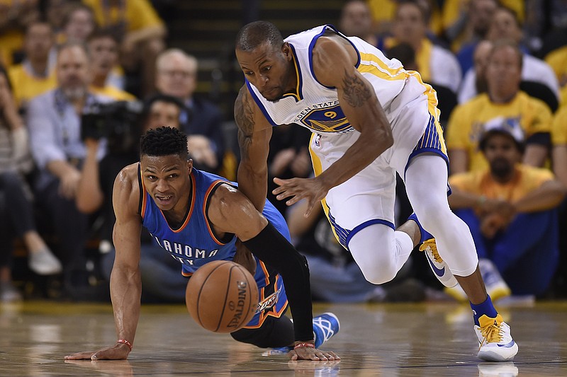 Oklahoma City Thunder's Russell Westbrook (0) battles Golden State Warriors' Andre Iguodala (9) for a loose ball in the first quarter of Game 5 of the NBA Western Conference finals at Oracle Arena on May 26, 2016 in Oakland, Calif. Golden State defeated Oklahoma 120-111. 