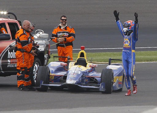 Alexander Rossi celebrates as he came to a stop in the fourth turn after running out of fuel after winning the 100th running of the Indianapolis 500 auto race at Indianapolis Motor Speedway in Indianapolis, Sunday, May 29, 2016.