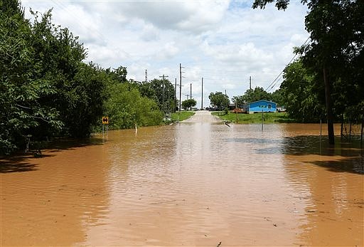 Sixth Street in Rosenberg, Texas, is impassible Sunday because of rising flood waters from the Brazos River.
