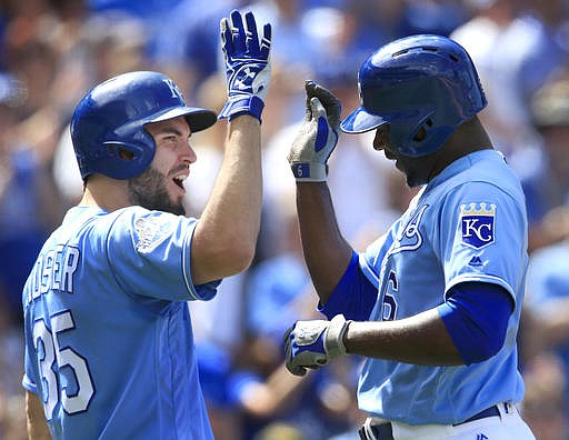 Kansas City Royals' Eric Hosmer (35) congratulates teammate Lorenzo Cain (6) on his solo home run during the eighth inning of a baseball game against the Chicago White Sox in Kansas City, Mo., Sunday, May 29, 2016. 