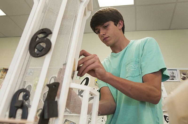 Pleasant Grove High School sophomore Ben LeGrand works on an assembly project May 23. "After the success of my last project I feel some pressure that this one has to live up to that standard so I'm going to take the summer to make it work," Ben said. 