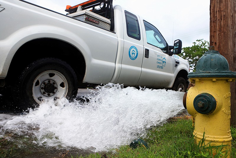 Water is flushed out from a hydrant May 14 on the corner of Glenmore and Kentner streets in Corpus Christi, Texas. The Texas Gulf Coast city has issued three orders in less than a year telling residents to boil their water to ensure it's safe to consume, including a two-week order this month that sparked outrage, contributed to the city manager's resignation and renewed questions about how to fix the problem. 